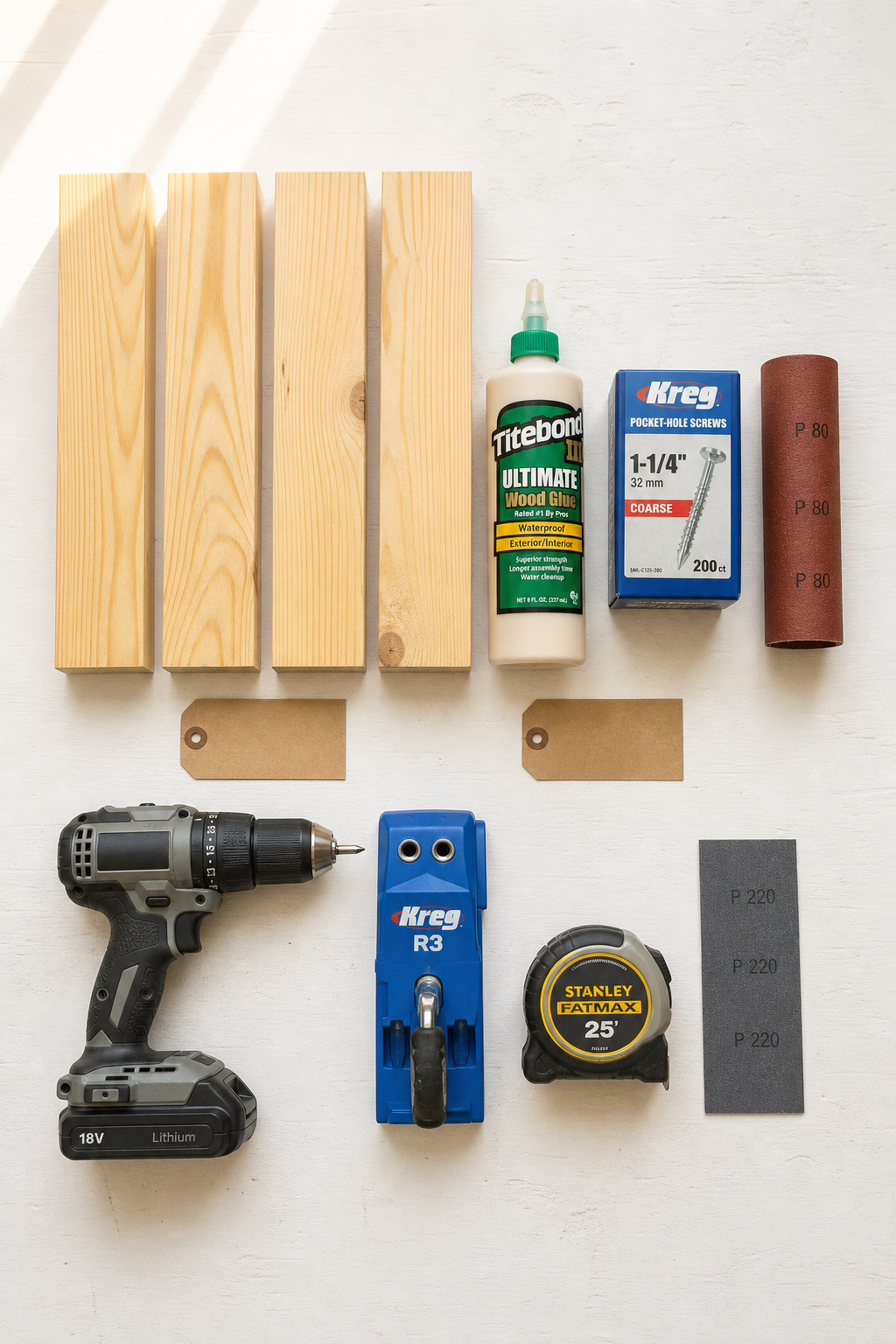 Flat-lay overhead of DIY barn door materials and tools: pine boards, wood glue, pocket screws, pocket-hole jig, drill, tape measure, and sandpaper