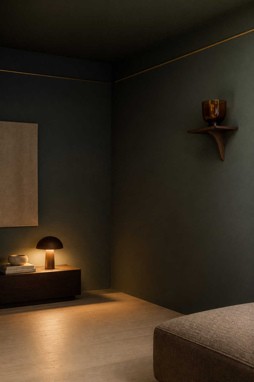 Living room corner where deep charcoal-green matte walls and ceiling share the same colour — the wall-to-ceiling junction dissolves, creating an enveloping jewel-box effect