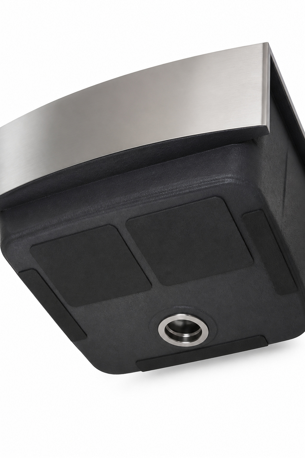 Underside of a stainless steel farmhouse sink showing rubber sound-dampening pads and sprayed undercoating for noise reduction
