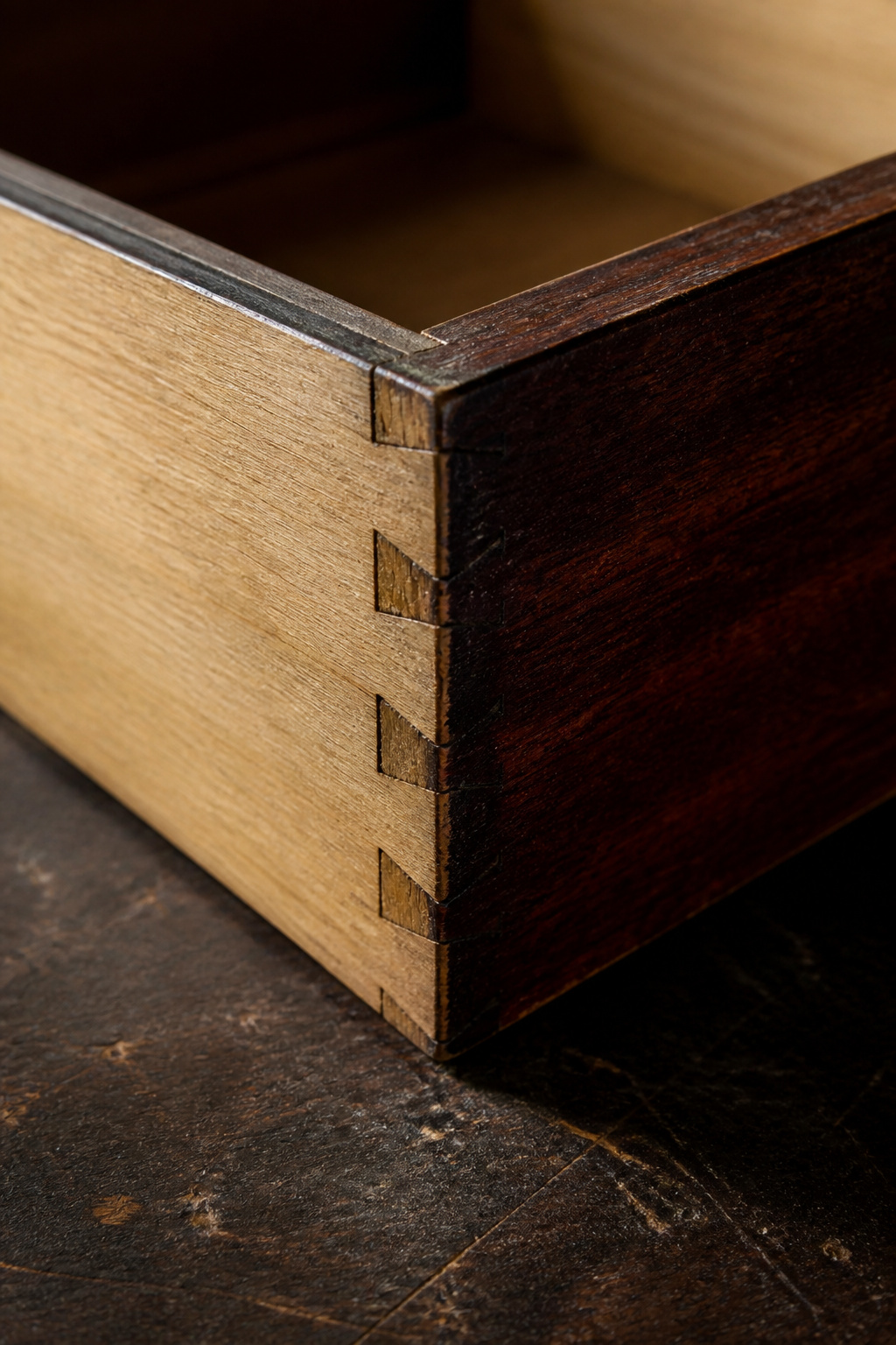 Victorian mahogany drawer corner showing hand-cut dovetail joints with uneven tail spacing, chisel marks, and white pine secondary wood