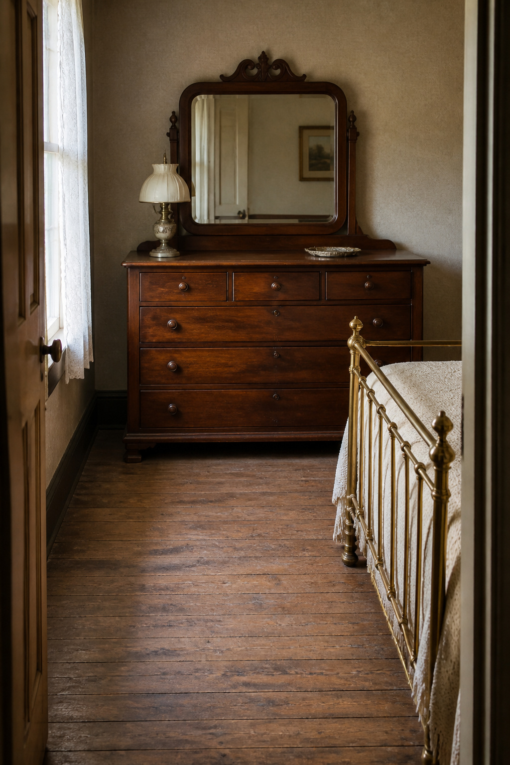 Victorian walnut dresser placed directly opposite a brass bed frame with clear floor circulation space between them in a period bedroom