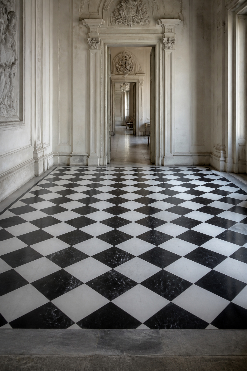 Black and white marble checkerboard floor set diagonally in a classical European interior with plaster mouldings and a chandelier