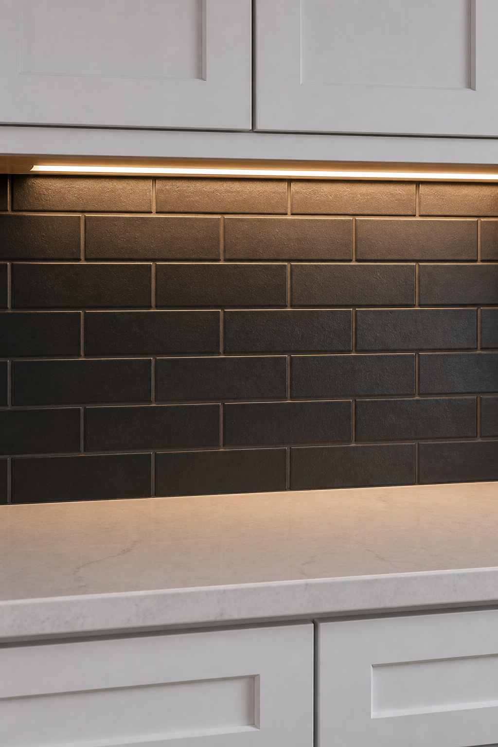 Deep charcoal matte subway tile backsplash with dark grout under white kitchen cabinets, lit by under-cabinet LED strip