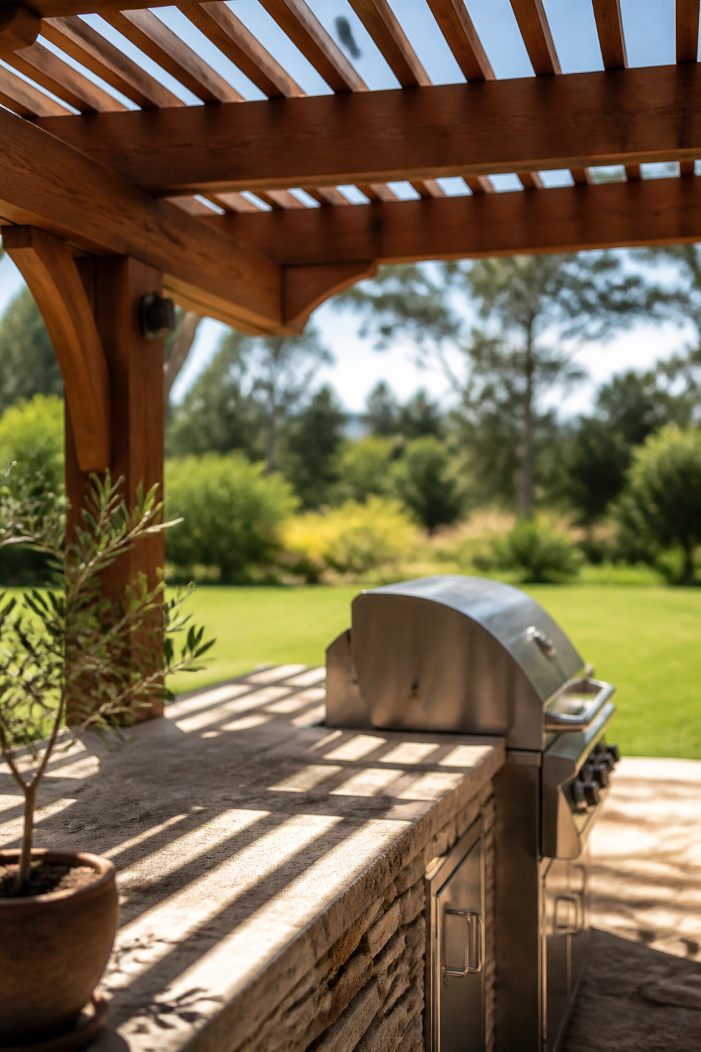 Open cedar pergola casting dappled shade over an outdoor kitchen counter