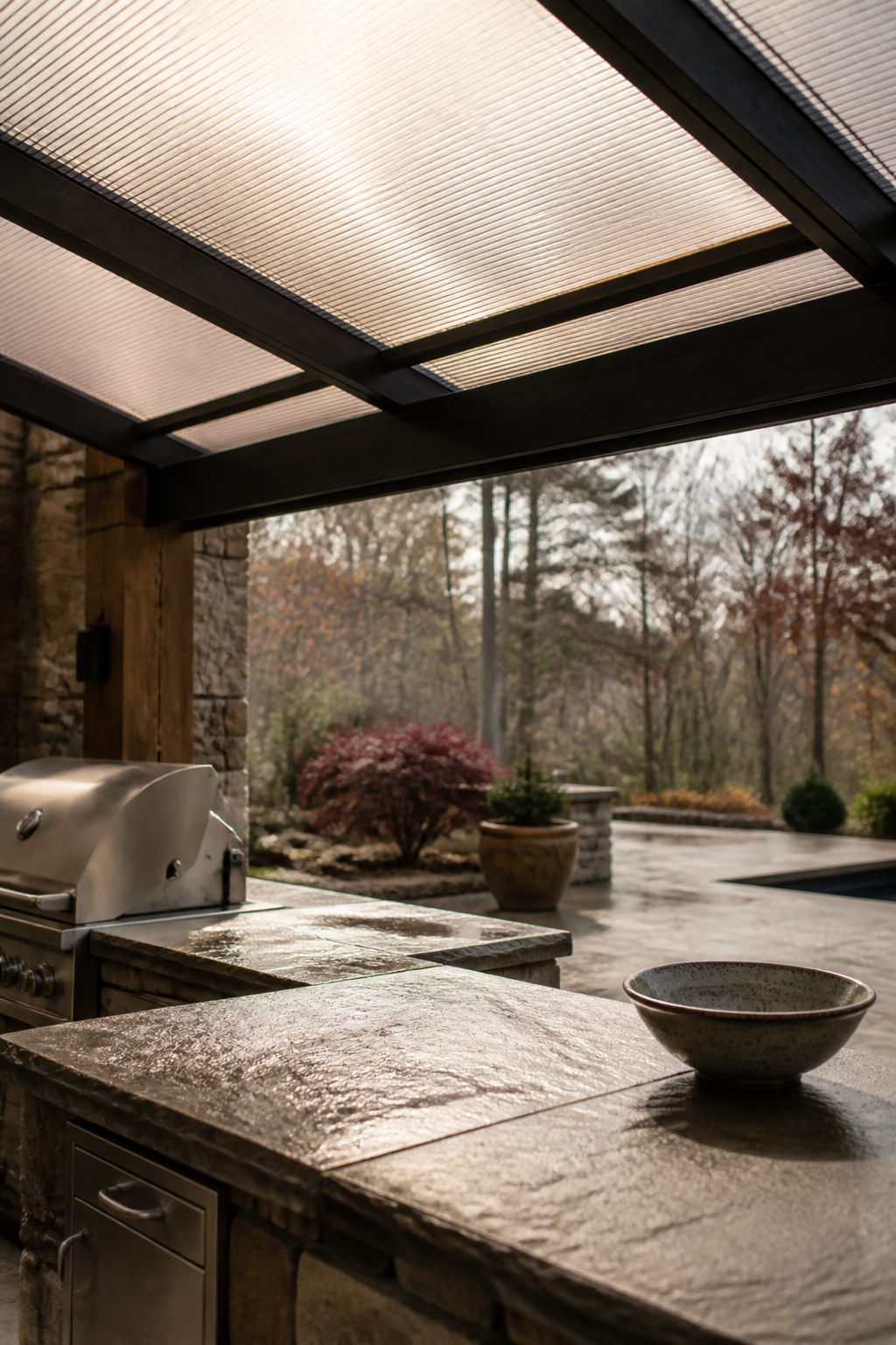 Tinted polycarbonate panel roof diffusing sunlight over an outdoor kitchen counter after rain