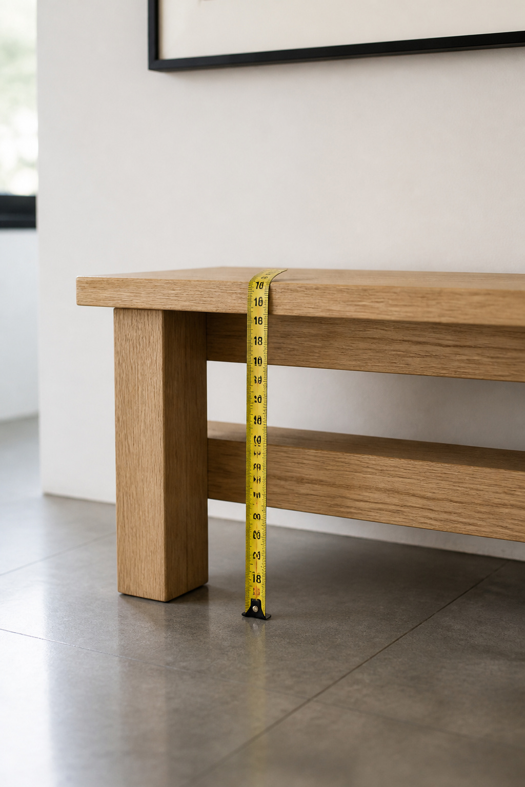 Side view of an oak entryway bench with a measuring tape showing an 18-inch seat height from the floor