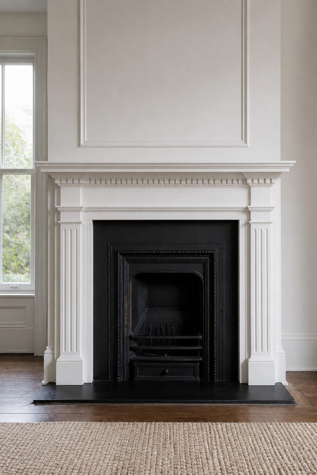 Traditional white Georgian fireplace surround with pilasters and dentil cornice, showing architectural detail of the mantel shelf