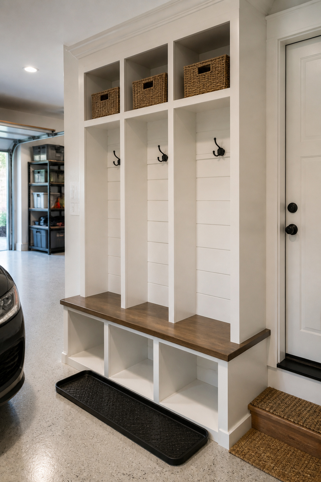 Built-in cubby and bench unit installed against a flat garage entry wall as a no-closet storage solution