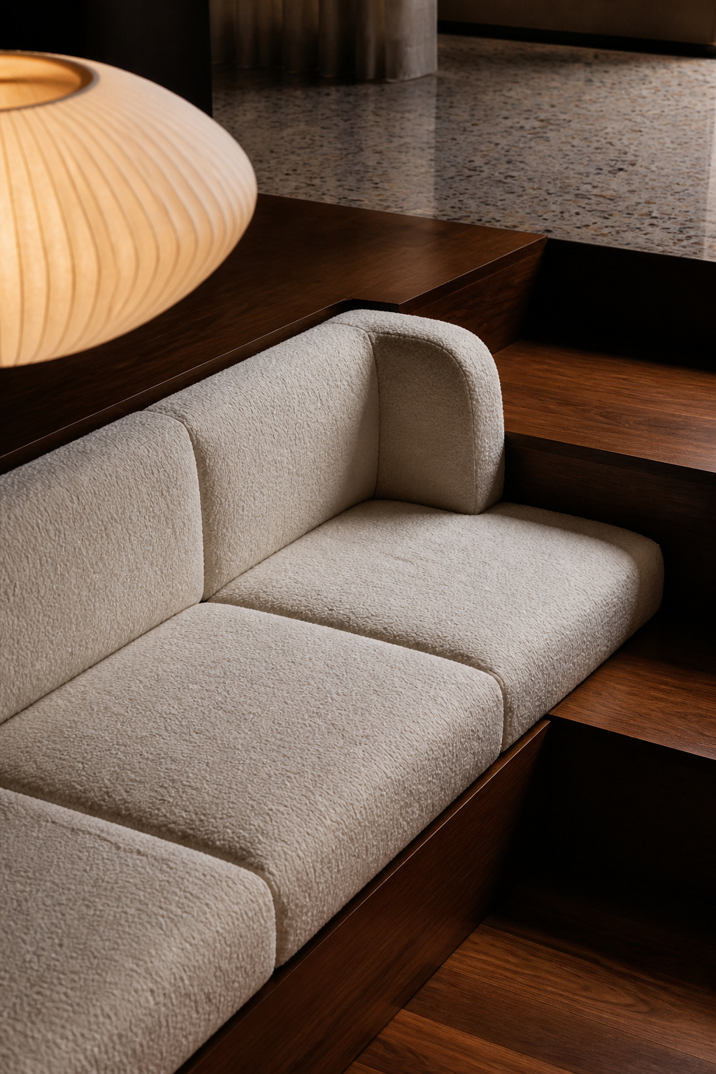 Sunken living room bench reupholstered in ivory bouclé on its original walnut step structure