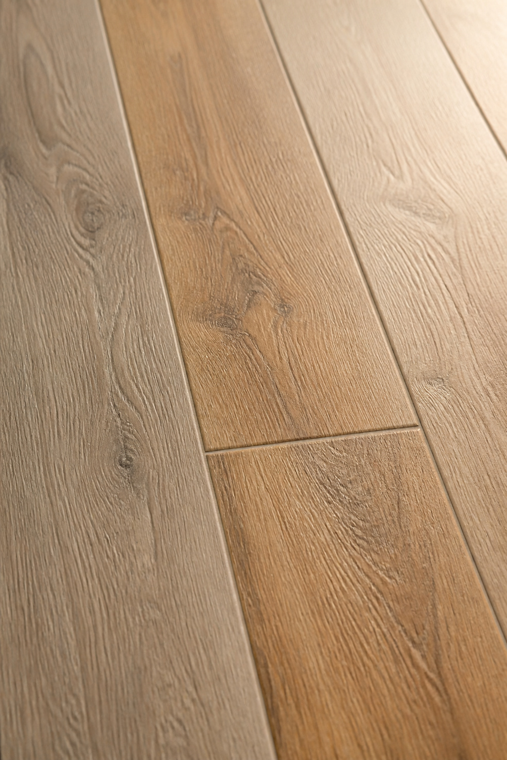 Close-up of three matte porcelain wood-look planks showing EIR embossed grain texture and V3 colour variation