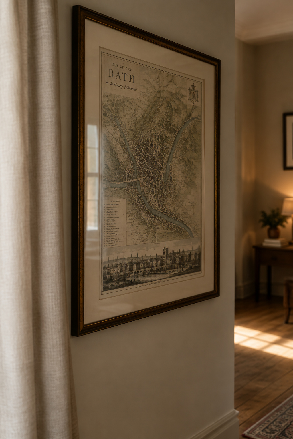 Framed antique-style print hung on a wall away from a shaft of direct sunlight crossing the floor near a curtained window
