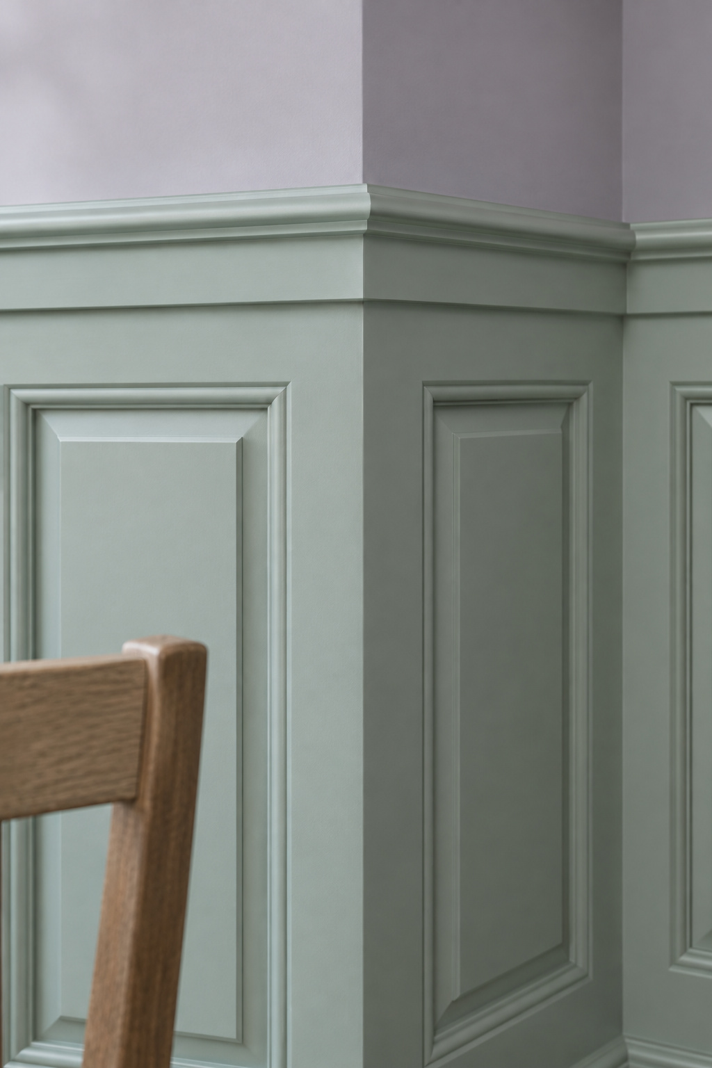 Close view of a celadon raised panel wainscot with a stepped cap and deep bevel shadow lines